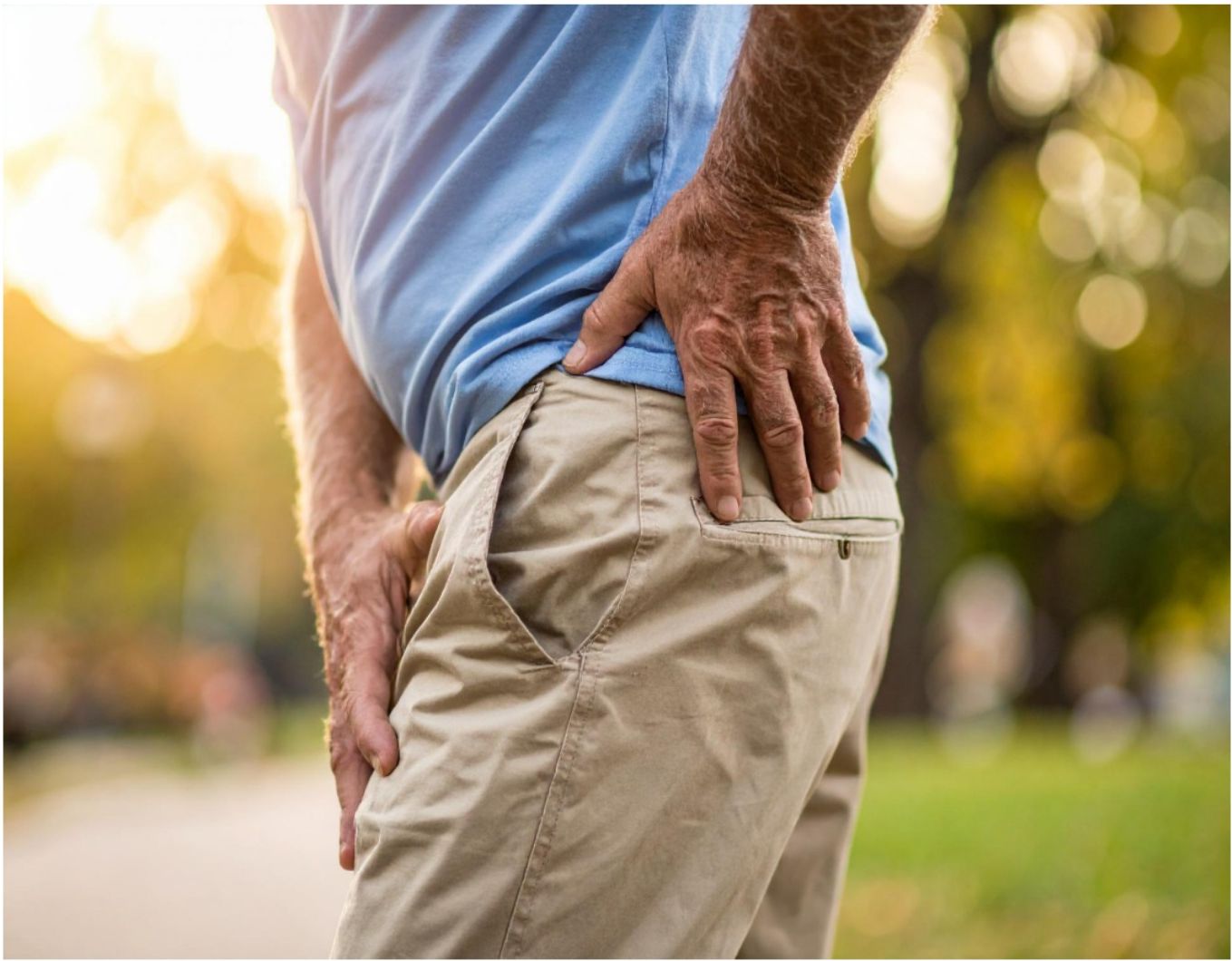 A person holding their hip in pain